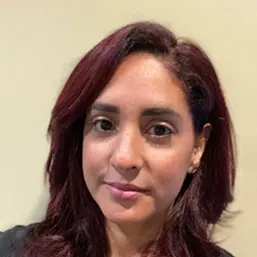 a woman with red hair is smiling for the camera